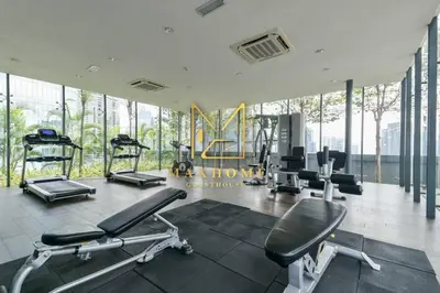 a gym with treadmills and machines in a room with windows at Maxhome@Dorsett Residence , KL in Kuala Lumpur