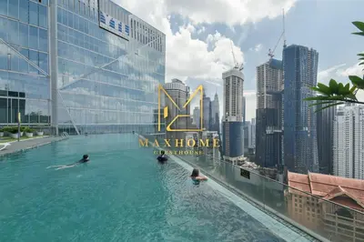people swimming in a infinity pool on the roof of a building at Maxhome@Dorsett Residence , KL in Kuala Lumpur