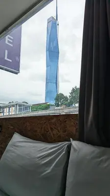 a bedroom with a view of a tall building at i-Hotel Kuala Lumpur in Kuala Lumpur