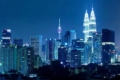 a nighttime view of a large city with tall buildings at Avenue K in Kuala Lumpur