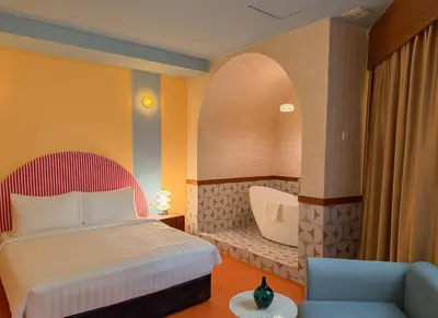 a bedroom with a bed and a bath tub at The Très Hotel in Kuala Lumpur