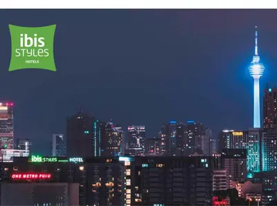 a view of a city at night with the seattle needle at Ibis Styles Kuala Lumpur Fraser Business Park in Kuala Lumpur