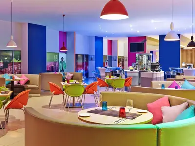 a restaurant with colorful furniture and tables and chairs at Ibis Styles Kuala Lumpur Fraser Business Park in Kuala Lumpur