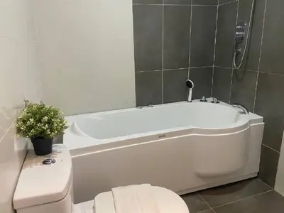 a bathroom with a white bath tub and a toilet at Asia Like Boutique Hotel in Kuala Lumpur