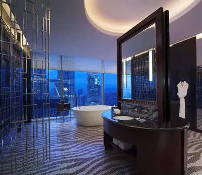 a bathroom with a tub and a large mirror at Grand Hyatt Kuala Lumpur in Kuala Lumpur