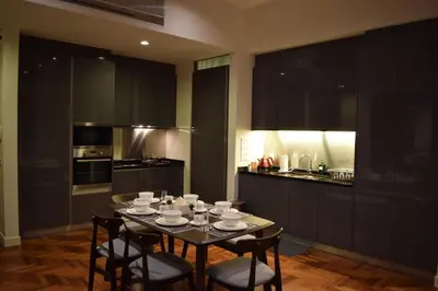 a kitchen with a table with cups and saucers on it at KLCC The Mews Home in Kuala Lumpur