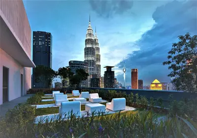 a group of white chairs and a city skyline at KLCC The Mews Home in Kuala Lumpur