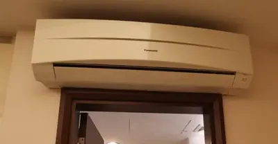 a white ceiling fan in a room with a mirror at Corporate hotel suites at hartamas / mont kiara in Kuala Lumpur