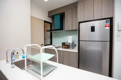 a kitchen with a refrigerator and a counter top at Velocity KL By PSM Luxury Suites in Kuala Lumpur