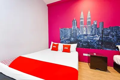 a bedroom with a red and white bed and a city at Hotel O Elwarda Klcity in Kuala Lumpur