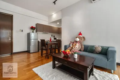 a living room with a teddy bear sitting on a couch at Regalia Residence by FANTASTIC in Kuala Lumpur