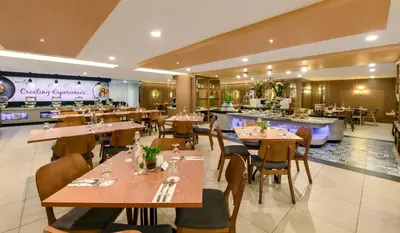 a restaurant with tables and chairs and a bar at AnCasa Hotel Kuala Lumpur, Chinatown in Kuala Lumpur
