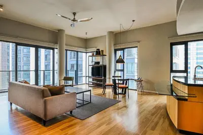 a living room with a couch and a table at E&O Residences Kuala Lumpur in Kuala Lumpur