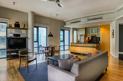 a living room with a couch and a table at E&O Residences Kuala Lumpur in Kuala Lumpur