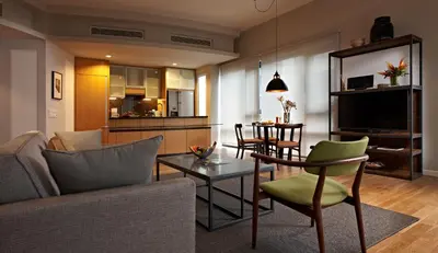 a living room with a couch and a table at E&O Residences Kuala Lumpur in Kuala Lumpur