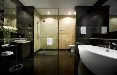 a bathroom with a tub and a toilet and a sink at E&O Residences Kuala Lumpur in Kuala Lumpur