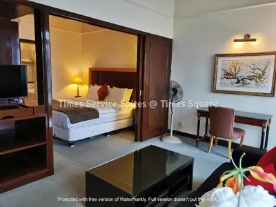 a hotel room with a bed and a desk at Times Service Suites @ Times Square in Kuala Lumpur