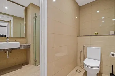 a bathroom with a toilet and a sink at Anggun Residences Serviced Suites in Kuala Lumpur