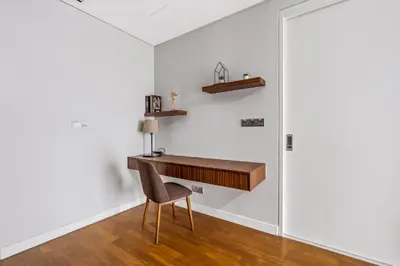 a desk in the corner of a room with a chair at Anggun Residences Serviced Suites in Kuala Lumpur