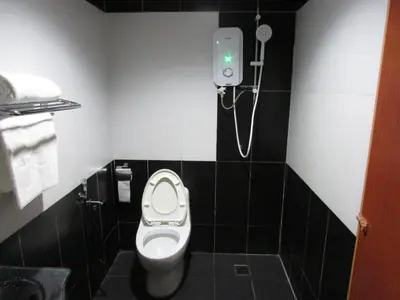 a bathroom with a toilet and a shower at Safari Hotel in Kuala Lumpur