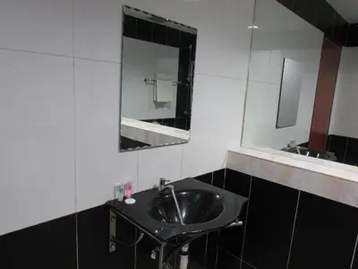 a bathroom with a sink and a mirror at Safari Hotel in Kuala Lumpur