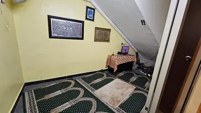 an attic room with a stairway with a table and a stairwayngth at Safari Hotel in Kuala Lumpur