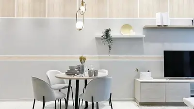 a dining room with a table and chairs and a tv at The Robertson Bukit Bintang in Kuala Lumpur