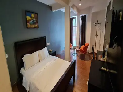 a bedroom with a bed and a blue wall at Hotel O Crossroads Hotel in Kuala Lumpur