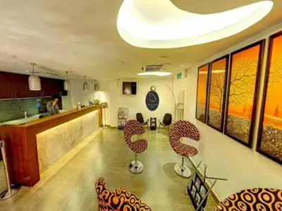 a room with a bar with chairs and a counter at Hotel O Crossroads Hotel in Kuala Lumpur