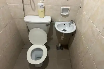 a small bathroom with a toilet and a sink at Sha La La Hostel in Kuala Lumpur