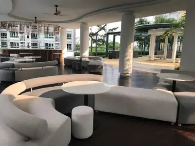 a lobby with white furniture and tables and a building at Velocity Residence in Kuala Lumpur