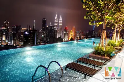 a large swimming pool with a city skyline at night at Expressionz Suites near KLCC, IJN by Wodages in Kuala Lumpur