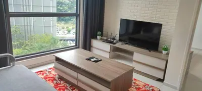 a living room with a flat screen tv and a large window at The Robertson Bukit Bintang by Wowhome in Kuala Lumpur