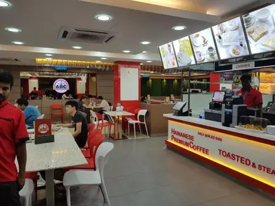 people sitting at tables in a fast food restaurant at My Hotel @ KL Sentral in Kuala Lumpur