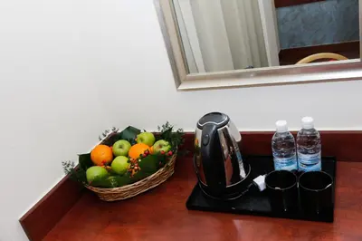 a tray with a tea kettle and a basket of fruit at My Hotel @ KL Sentral in Kuala Lumpur