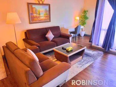 a living room with a couch and a table at The Apartments at Times Square KL by Robinsons in Kuala Lumpur