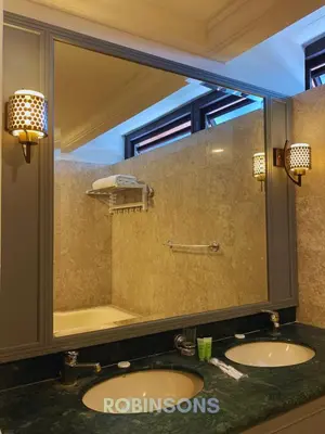 a bathroom with two sinks and a large mirror at The Apartments at Times Square KL by Robinsons in Kuala Lumpur
