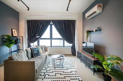 a living room with a couch and a tv at Arte Plus by Cobnb KLCC in Kuala Lumpur