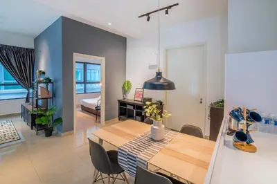 a dining room and living room with a table and chairs at Arte Plus by Cobnb KLCC in Kuala Lumpur
