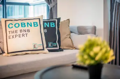 a couch with a sign that reads columbine the bbn expert at Arte Plus by Cobnb KLCC in Kuala Lumpur