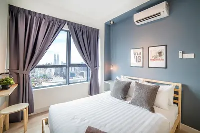 a bedroom with a bed with a large window at Arte Plus by Cobnb KLCC in Kuala Lumpur