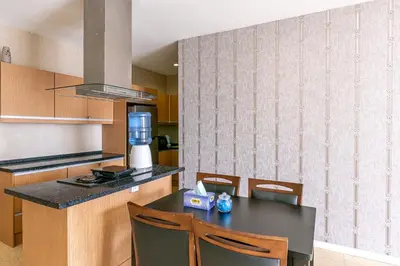 a kitchen with a table with chairs and a blender at Rex Ollie @ 231 TR Suite in Kuala Lumpur