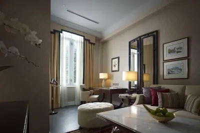 a living room with a couch and a table at The Majestic Hotel Kuala Lumpur, Autograph Collection in Kuala Lumpur