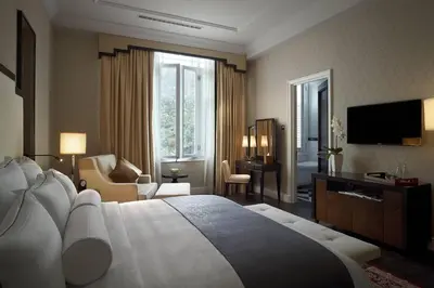 a hotel room with a large bed and a television at The Majestic Hotel Kuala Lumpur, Autograph Collection in Kuala Lumpur