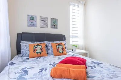 a bedroom with a bed with orange pillows at PV21 Setapak, Share House Room Only in Kuala Lumpur