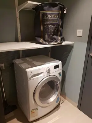 a bag sitting on top of a washing machine at Sunway Velocity V Residence Suites in Kuala Lumpur