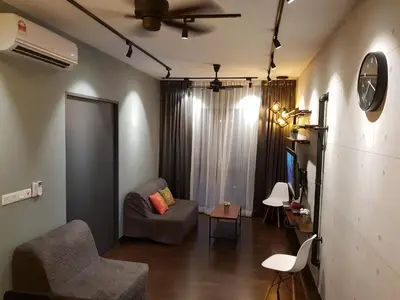 a living room with a couch and a tv at Sunway Velocity V Residence Suites in Kuala Lumpur