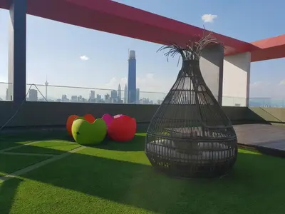 a balcony with a vase on the grass with apples at Sunway Velocity V Residence Suites in Kuala Lumpur
