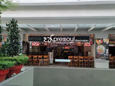 a restaurant with tables and chairs in a building at Sunway Velocity V Residence Suites in Kuala Lumpur