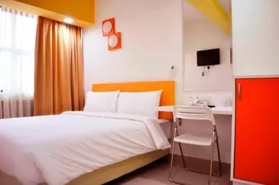 a bedroom with a bed and a desk and a television at YY318 Hotel Bukit Bintang in Kuala Lumpur